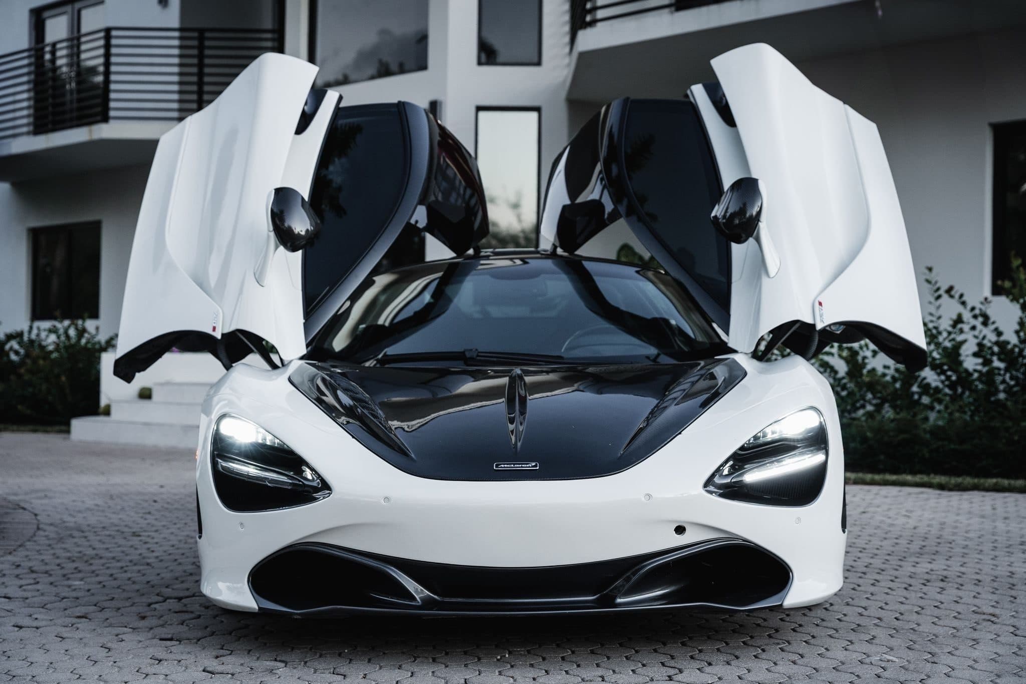 White McLaren 720S with its doors up